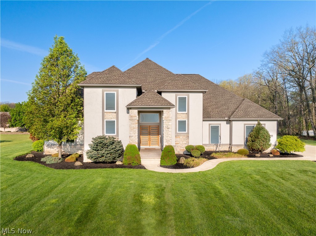 Welcome to this one-owner, custom-built residence by Victory Gate Custom Homes, ideally situated in the heart of Jackson Township. Showcasing luxury living with a refined modern aesthetic, this exceptional property offers a thoughtfully designed open-concept floor plan with over 4,500 square feet of meticulously maintained living space. Featuring 4 bedrooms and 3.5 bathrooms, this exquisite home was crafted to impress even the most discerning buyer. From the moment you step inside, soaring ceilings and a dramatic stainless steel turned staircase create a striking first impression. The spacious first-floor primary suite serves as a private retreat, complete with a spa-inspired bath designed for comfort and relaxation. A chef’s kitchen flows seamlessly into the main living and entertaining areas, while the covered rear porch overlooks nearly one acre of professionally landscaped grounds. Designed for both everyday living and entertaining, the finished lower level features a wet bar, media area, full bath, and dedicated fitness space. Additional highlights include a private office with French doors and a cathedral ceiling located on the staircase landing, as well as a fully integrated Control4 smart home sound system throughout. This one-of-a-kind property seamlessly blends sophisticated design, premium finishes, and exceptional functionality in one of Jackson Township’s most desirable locations. Schedule your private showing today.