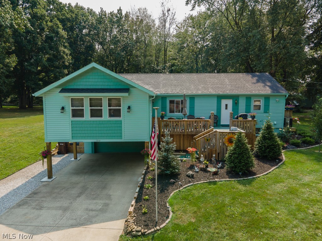 Lovely, updated 4 BR, 2-1/2 BA Ranch on .6615 acre. Huge addition of 19x19 living room w/built-in electric fireplace, opens to dining room & then totally remodeled, fully applianced eat-in kitchen w/island & breakfast bar overlooking the huge front porch. 1st floor master bedroom w/walk-in closet & master bath w/walk-in shower & soaker tub. Other end of the house has 2 more bedrooms w/double closets, main bathroom, & 1st fl laundry/utility room.  Finished, walk-out lower level includes 4th bedroom, rec room w/gas fireplace, & half bath w/toilet, urinal, vanity/sink & utility tub combined w/utility/furnace room. Attached garage is heated w/30,000 BTU gas heater, has 220 electric, water, opener & keypad, & there is a 2-car carport in front of garage, along w/a 60-foot extra lane along the driveway for your boat/RV. All kitchen appliances stay along w/washer, dryer, 2nd fridge, dehumidifier, 65" & 75" Samsung Q-series TV's, & Craftsman 42" cut riding mower w/dump/yard trailer, 2 sheds. Al