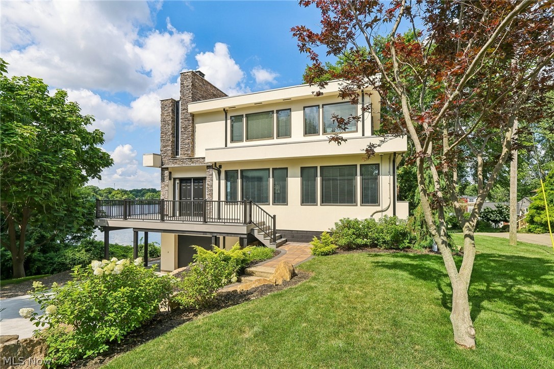 Enjoy beautiful lakefront views from this well-maintained contemporary home in the desirable Lake O'Springs community. Located on a quiet dead-end street in the highly rated Jackson Local School District, this move-in ready home offers 3 bedrooms, 3 full bathrooms, and an open main level filled with natural light, where expansive windows showcase the peaceful waterfront setting.

The spacious great room features a floor-to-ceiling stone wood-burning fireplace and flows into the updated kitchen with granite countertops, creating a comfortable and functional layout for everyday living and entertaining.

The upstairs primary suite serves as a private retreat with an adjoining morning room and large windows overlooking the lake. Two additional bedrooms and three full bathrooms provide plenty of space for family and guests. The walkout lower level includes an office, an additional bedroom with sliding glass doors to the backyard, and a full bathroom with a Jacuzzi tub. A lower-level patio provides another space to relax and enjoy the outdoors.

Thoughtfully updated in 2022, this home features a remodeled kitchen, fresh interior paint, newer carpet, and numerous additional interior updates. A new concrete driveway and wraparound deck were completed in 2026. The property consists of three parcels and, unlike many homes in Lake O'Springs, there is no HOA.

Whether you're looking for a full-time residence or a peaceful retreat to escape the pace of everyday life, this home offers beautiful lake views, thoughtful updates, and a setting you'll enjoy in every season.