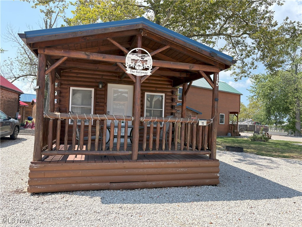The name of this cabin says it all, "The Getaway", located in the Cabins on the Lake Association in Saybrook Township, on the banks of Lake Erie.  Charming and efficient home with the perks of being in a lakefront community with direct lake access just a short walk from your covered front porch. Stay in the cabin for your perfect vacation or Airbnb when you are not in it. The Annual rental fee of $1,000.00 is paid for 2026. This cabin is being sold fully furnished and includes all the stainless steel appliances. Gas hookup is available to switch from electric that currently heats and cools this home.  Storage shed included.  Relax around the firepit and enjoy peaceful summer nights!  Close to historic Bridge street with shopping, restaurants and also not far from all the entertainment at the strip at Geneva-on-the-lake.