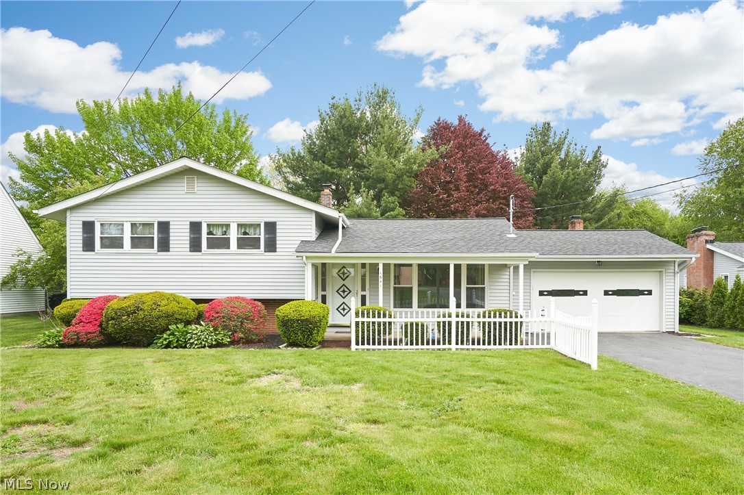 Welcome to this well-maintained 3-level split featuring 4 bedrooms, 1.5 baths, and family room located on the main floor. Stunning LVP flooring recently updated in family room along with a gas fireplace adds to the comfort of this home. A slider leads to the back concrete patio with a charming backyard for entertaining. 1/2 bath is conveniently located off the attached garage which leads directly to the kitchen for easy access with groceries! You'll find a bright inviting living room with newer windows leading to a  covered front porch to relax on with your morning coffee. (Carpet can easily be replaced with the original hardwood floors that are hiding beneath if so desired). A formal dining room boasts with a chandelier centered between the kitchen and living room for hosting holiday dinners. Beautiful hardwood floors run throughout the 3 upstairs bedrooms offering ample closet space along with a generous storage cabinet in the full bath. The finished basement adds valuable additional living space with a 4th bedroom, recreation area, utility room, storage galore, and access to furnace in the crawl space. Walkout basement adds additional privacy for the lower level and glass block windows for security.  A turn around asphalt driveway for extra parking and accessibilty. Located just minutes away to highway access, restaurants, shopping and all amenities. A Home Warranty is also being offered for Buyer's peace of mind! This is a wonderful opportunity to own a comfortable home even though a bittersweet estate sale. Add your own touches and simple updates - so much to offer and extremely low taxes.  Schedule your showing today!