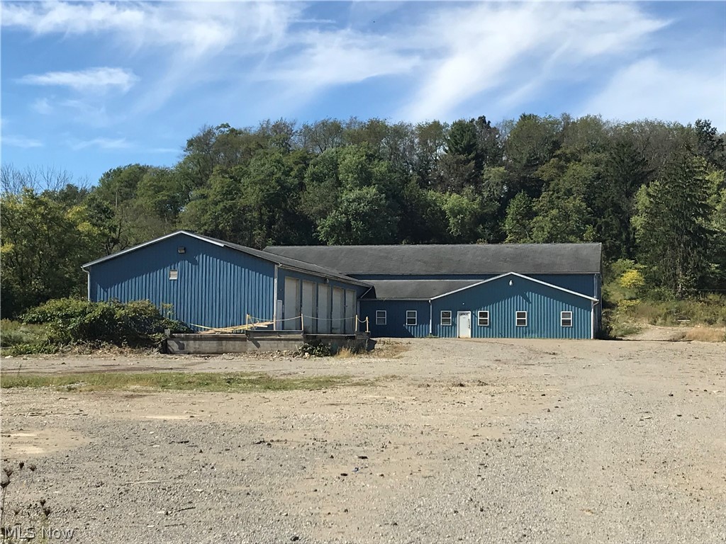 11,440 square foot metal sided pole building.  10' ceilings throughout the 5 offices/reception areas.  Electric furnace and central air in the office area.  3 bays with concrete floors, metal ceilings and shop/florescent lighting.   50 X 60 mezzanine with 18' ceilings and man door to the outside.  18' ceilings in the 50 X 60 section with 1-14' overhead door.  14' ceilings in the 40 X 100 section with 5-12' overhead doors.  Heating system for the 3 bays is not working.  Sells as is.  Available for sale or lease.  Great investment opportunity. Water and sewer available on the other side of Stonecreek Road.   Also available for lease, see mls#4140791.