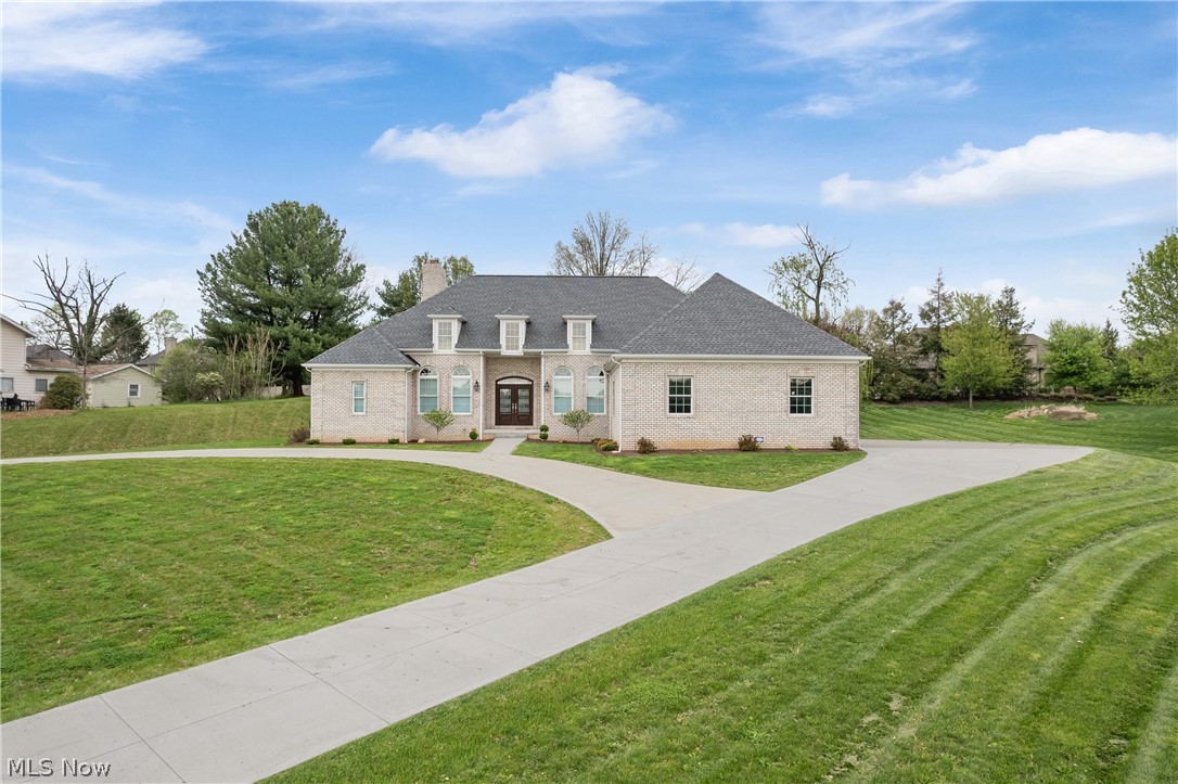 NOW, Look at This!!! Custom Built in 2019. This all brick Ranch with 3-bedrooms, 2.5-baths offers 2,650 sq ft with a split bedroom floorplan, One floor living with 12-foot ceilings, wide hallways, and a wheelchair-accessible entry. Positioned well off the road with a circular driveway, the property provides a quiet, private setting. The open layout features a spacious great room with a wood-burning fireplace (gas starter), and large windows that bring in abundant natural light. The kitchen is both functional and refined, offering granite countertops, tile backsplash, a large island with cooktop and range hood, soft-close cabinetry, and stainless steel appliances. The breakfast bar connects to the dinette area for easy everyday living. The primary suite includes a tray ceiling, walk-in closet, and a well-appointed bath with double vanity, jetted tub, and tiled beautiful walk-in shower with rain shower heads. Bedrooms two and three are spacious and accommodated by a shared bath. Additional main-level spaces include a formal dining room, private office, laundry room with sink and cabinetry, and an additional half bath. The full 13-course basement is plumbed for a future bath and includes a central vacuum system. The heated, oversized four-car garage features deep bays, large doors, and hot and cold water access. A whole-house Generac generator adds convenience and peace of mind. A thoughtfully designed, one owner  home offering space, quality, and a desirable location.