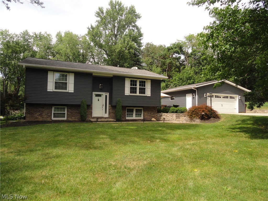 Situated toward the end of Perry Rd near the cul de sac is this beautifully maintained and updated home. Extensive renovations including a 25 x 16 family room / kitchen addition that has a beamed cathedral ceiling, gas fireplace, extra large windows bringing in the sunlight and bamboo wood floors that continue throughout and into the formal living room. The kitchen has beautiful wood cabinets, granite counters, high end stainless appliances, spacious dining area plus a large breakfast bar. The main level has two bedrooms plus a full bath and the lower level has two more bedrooms with another full bath. Plus there is a large finished rec room plus an additional 400 sq ft basement or  second rec room as part of the addition and it walks out to the side yard. Sharp curb appeal with leaded glass door, nicely landscaped including a paver patio and fire pit, newer vinyl siding, new roof in 2012, a 2.5 car garage with a double concrete driveway offering plenty of room to park or play. Must se