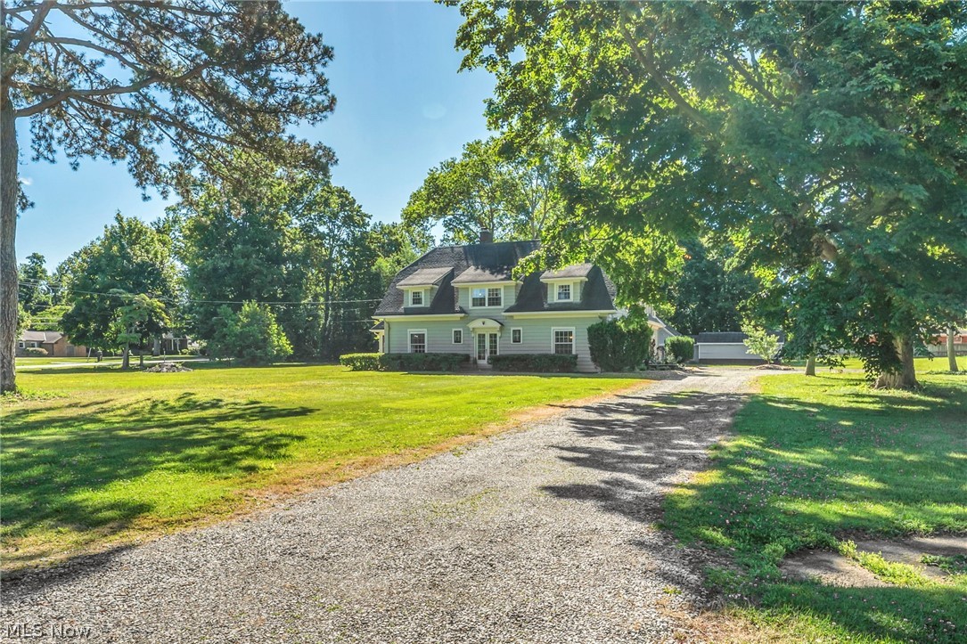 ~Charming Cape Cod/Craftsman~ rich in character, history, and opportunity~ Situated on a rare parcel of over 2 acres, this handsome property offers privacy, flexibility, and room to grow. Extensive parking and wraparound drives on both sides and behind the home create convenience rarely found. Numerous outbuildings are already in place and offer tremendous potential for the next owner. While they would benefit from restoration, updates, or reimagining, they provide a rare opportunity to create your vision. Dramatic double doors welcome guests into the family room. The formal dining room is complemented by a separate serving area hidden behind doors, ideal for linens and entertaining essentials. The oversized living room features a fireplace and access to the screened porch. A custom library with built-ins offers flexibility as a home office, reading retreat, morning room, or breakfast nook. The updated kitchen opens to one of the home's standout features—a recreation/great room with beamed ceiling, oversized stone fireplace, rich wood paneling, and hidden Prohibition-style bar. Another nook with estate safe adds personality and storage. This home is suited for multi-generational living, extended family, long-term guests, or private teen quarters. In-law suite features two rooms, living area, full bath, and private staircase access. Five additional bedrooms provide room for everyone.  Upstairs you'll find the primary suite with private bath, additional bedrooms, and a full bath separate from the in-law quarters. The lower level has been refreshed and offers additional usable space. Lovingly restored while preserving its original charm, **ask for the extensive update list including the new boiler system & matterport tour link** Still room for your finishing touches and vision. Rare. Flexible. Memorable. Properties offering acreage, character, multi-generational living, and future potential seldom become available. *Full Photo Set in pictures*By apt.~ private tour only