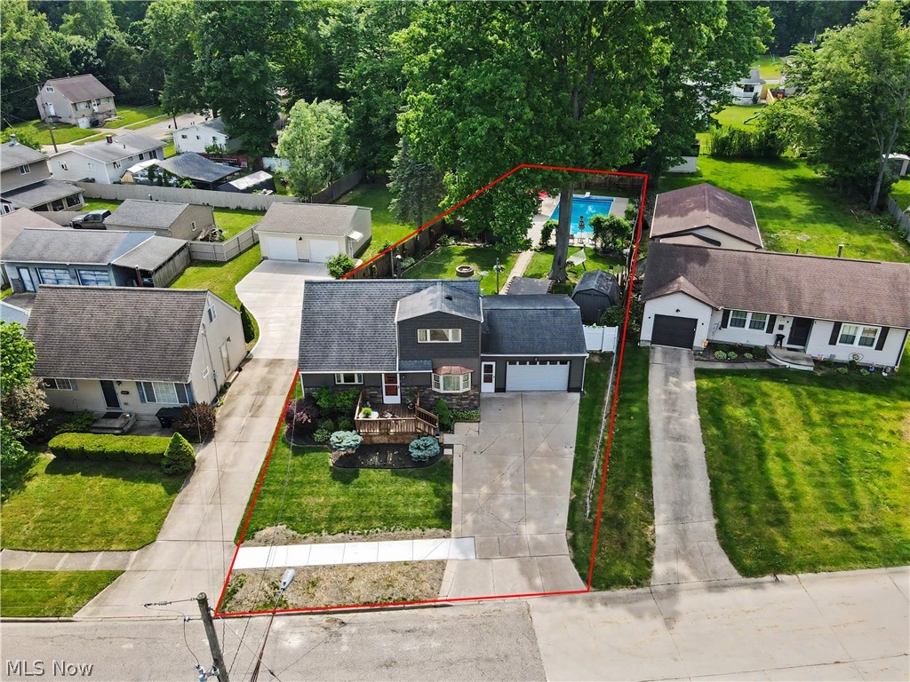 Welcome home to this exceptional 4-bedroom, 1.5-bath property offering space, updates, and an incredible backyard retreat with a large in-ground heated pool to enjoy this summer! The versatile floor plan features two first-floor bedrooms and a full bath, providing convenient one-floor living options.  Updated in March 2019, the beautiful kitchen will impress you with cabinets, quartz countertops, an elegant Italian marble backsplash, and a breakfast counter overlooking the stunning backyard oasis through the large window. The first floor full bath was also updated in 2021. The second level features two more bedrooms with half bath.  The basement is partially finished and would be a great space for an exercise room, recreation room - or whatever fits your needs.  Step outside and enjoy summer to the fullest with the in-ground heated pool and included arched cabana—perfect for entertaining family and friends. The pool is 18' x 30' in size and is 3' - 10' deep.  There are two sheds - one is considered the "Pool/Pump House" for the pool equipment and supplies and the other for all of the yard items.   Other updates feature: Solar pool cover - 2026; Furnace, AC  and pool pump - 2025; Winter Pool Cover - 2024 and Washer/Dryer - 2021; Vinyl Siding and Windows - 2019.  Car enthusiasts, hobbyists, or anyone needing extra workspace will appreciate the insulated and heated oversized one car garage including a 220 volt. Situated on three parcels, this property boasts a super large yard in the Ellet area, offering endless possibilities for recreation, gardening, entertaining, or simply enjoying your own private outdoor sanctuary.  This home a truly special gem.