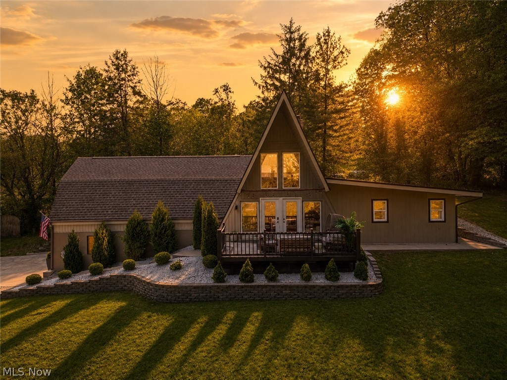 Set in a peaceful, secluded location just minutes from town, this A-frame style home offers the kind of privacy that is hard to find. Situated on just over 4 acres, with much of the land wooded, the home sits toward the top of the hill overlooking a serene woodland view. Whether enjoying a quiet morning coffee or winding down in the evening, the front porch offers a completely private setting surrounded by trees, wildlife, and the calm of the outdoors—yet New Philadelphia and the amenities of town are only a 5–10 minute drive away. The home offers 1,400 sq. ft. of living area with 3 bedrooms and 2 full baths. Inside, you’ll find warm wood accents, vinyl flooring, newer fixtures, and a pellet stove insert in the fireplace that adds comfort and character to the main living area. The kitchen features painted cabinetry, backsplash, new sink, and appliances that stay. A loft above the kitchen provides flexible bonus space for an office, reading nook, or additional sleeping area. The main floor includes a full bath with tiled shower, laundry area with washer and dryer, and a bedroom currently used as a playroom. Upstairs are two additional bedrooms and a full bath with glassed-in walk-in tile shower, and modern finishes. Outdoor improvements include concrete walks and patio areas, lighted steps, retaining walls, new landscaping, newly reseeded lawn, under-eave lighting, and new gutters/downspouts. Additional features include central air/heat pump, one-car attached garage with electric opener, storage shed w/lean-to, raised garden beds, and a small chicken coop. A rare combination of privacy, usable acreage, and convenience in Indian Valley Schools.