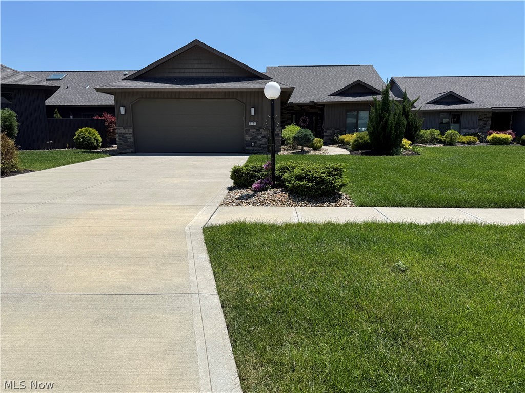 Welcome to effortless luxury living in the highly desirable Ridgefield community by Bob Schmitt Homes, where modern design meets low-maintenance convenience. This beautifully appointed cluster home offers the convenience of included snow removal and lawn maintenance, allowing you more time to enjoy everything this home has to offer.

Step inside to an open, thoughtfully designed floor plan featuring a stunning kitchen with sleek cabinetry, oversized island, quartz surfaces, stylish lighting, and seamless flow into the spacious living and dining areas—perfect for everyday living and entertaining.

The primary suite is a true escape with a custom accent wall, spa-inspired bath featuring a large glass-enclosed tile shower, and an impressive walk-in closet with built-in organization. A versatile additional space showcases a custom Murphy bed, providing the perfect blend of home office, guest suite, or flex room functionality.

Outdoor living shines with a spectacular covered patio featuring exposed beams, stone accents, and ample space to relax or entertain, overlooking the beautifully maintained yard and landscaping.

Enjoy the privacy and comfort of cluster living combined with the quality craftsmanship and attention to detail Bob Schmitt Homes is known for!