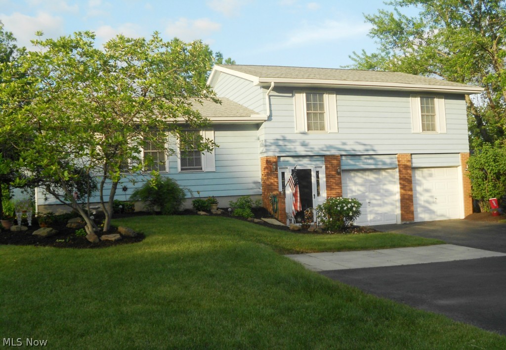 Sharp 4 Level Split offers 4 bedrooms & 2.5 updated baths.  This home has a spacious & inviting foyer to greet your family & friends.  The lovely kitchen features granite countertops, white cabinets & door to an upper level deck.  The formal living room & dining room have lots of natural light, plus there is a family room with sliders to the patio for additional room to entertain. A large master bedroom offers two closets (1 is walk-in) & a master bath.  There are ceiling fans and ample closet space in all 4 bedrooms.  The basement is separated into 3 areas to be used as you wish (the current owners have a rec room, bonus room & workshop in the basement).  Driveway features extra pad for additional parking or turn around for easy access to street.  Updates include newer roof, gutters, furnace/AC, electric panel, garage disposal, & windows.