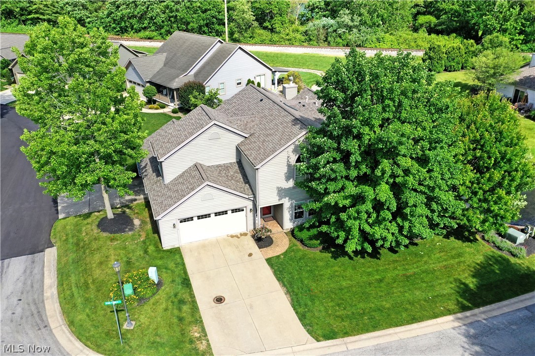 Looking for the perfect blend of low maintenance living and contemporary flair with gorgeous water views? Then stop right here because you've found it! Welcome to 102 Spinnaker Dr in Columbiana's Back Bay at Arrowhead Lake! Step inside and take note of the modern aesthetic with a stunning feature wall in the entryway. The kitchen is straight ahead and showcases two tone cabinetry (2050), contrasting dark countertops, and pantry storage. Steps away, the great room is a stunning space where a feature wall in the dining room (2025) creates a dramatic backdrop for meals as luxury vinyl flooring flows throughout the space. A stacked stone fireplace accents the living room as well as the sun room! The master bedroom is huge and has its own gas fireplace as well as a large ensuite bath with double vanity, soaking tub, and seperate shower. The laundry room and a convenient powder bath round out the first floor. Upstairs, a loft welcomes you as an additional living space including a built-in desk area. 2 more bedrooms await with one serving as a dressing room and the other being quite large with a walkin closet! A full bath with skylight joins the two bedrooms. The mechanical closet has tons of storage space as well.  Head outside to grab a waterside seat on the gorgeous paver patio and take it the relaxing sounds of the fountain while enjoying lake views! What are you waiting for? Call today for your personal tour of this fabulous condo! **HVAC 2021, HWT 2022, Fridge 2026.