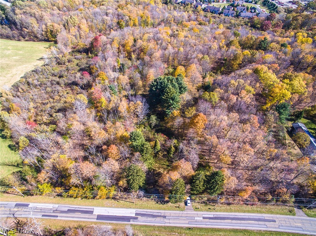 A chance to buy 5 acres in the Kenston School District. Geauga County taxes. Directly across the street from Frohring Meadows Park and less than 5 minutes to the Village of Chagrin Falls.  Mostly wooded lot with a pond and spring/creek near the rear of the property.  Additional 5 acres for sale.  See MLS