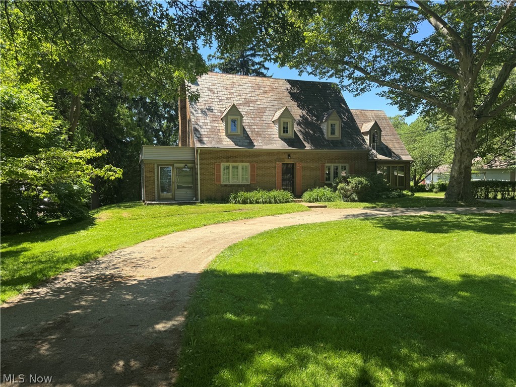 The minute you pull into the circle driveway, you'll feel the charisma of 1001 S. Main St.!  Featuring over 2,000 sq. ft., original hardwood flooring, a detached 24' x 24' garage and nearly an acre of land, this charming Cape Cod is full of character and move-in ready! The main level offers a fabulous large Living Rooom, complimented by the inviting Fireplace as well as the original hardwood flooring, all of which are laden with history!  The gorgeous Dining Room flows seamlessly from the Living Room to the Kitchen and gives you that "take me back in time" feeling as the tasteful chandelier will illuminate above your dining table of choice and the original swing door presents the perfect entrance/exit to and from the Galley Kitchen.  Providing plenty of cabinet and counter space, you'll enjoy prepping many a meal in the newly floored and painted kitchen, while also enjoying a beautiful birdseye view of the back yard.  Abutting the kitchen is an additional large space that can be utilized as a Den, Family Room, etc and is also adorned with hardwood flooring.  The Sun Room offers a great spot to relax and accesses both the front and back of the exterior.  Concluding the main level is yet another versatile space that can serve as an office, game room or whatever fits your needs.  Traversing the steps, you'll find the 3 Bedrooms, a Full Bathroom and a Bonus Room.  Aside from the Bonus Room (wood flooring), the entire second level has new flooring and freshly painted walls!  The Master BR offers his & her closets and accesses the usable rooftop "deck" while the Bonus Room could act as a 4th Bedroom.  Outside, you'll find mature trees, a large garage and a huge back yard.  Additional paved parking is available beside the garage.  Enjoy your tour!