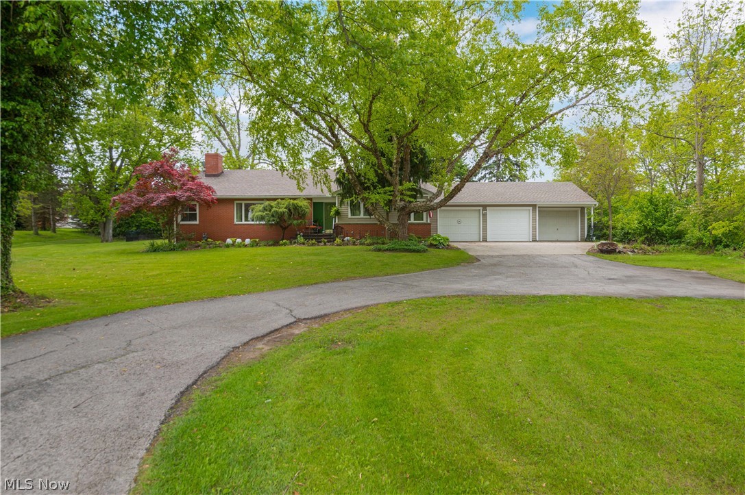 This gorgeous remodeled ranch sits perfectly on .79 acres, nestled among the trees, creating a tranquil and serene setting both inside and out. Step inside to an inviting entryway that opens into a bright and spacious open-concept living area filled with natural light. Elegant white pillars create a timeless separation between the foyer, dining space, and cozy living room, while large windows and glass doors bring in beautiful outdoor views, enhancing the warm and airy feel. A charming fireplace with rich wood accents serves as the focal point of the living area, creating the perfect blend of comfort and style. The bright and inviting eat-in kitchen features new windows, filling the space with natural light and peaceful views of the surrounding trees. Light cabinetry, updated flooring, and modern finishes create a warm and airy atmosphere, while the cozy dining area offers the perfect spot for everyday meals and gatherings. Offering 3 bedrooms, 2 full baths, and an attached office or flex room, this home combines comfort, functionality, and peaceful living all in one beautiful property. The basement offers endless potential for entertaining, storage, a home gym, or additional living space. Outside, enjoy a spacious backyard surrounded by mature trees, offering privacy, room to play, entertain, garden, or simply relax and enjoy the peaceful setting. With plenty of open green space and a serene natural backdrop, this backyard is the perfect extension of the home’s tranquil atmosphere. Additional updates include a new windows, roof, gutters with guards, and waterproofed basement for added peace of mind.