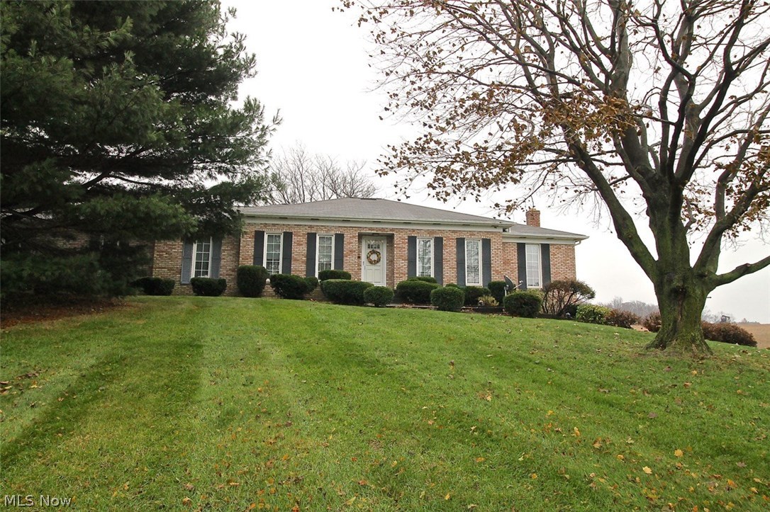 If you are looking for that perfect home on a nice plot of land with mature trees to make all your own, look no further. Take a look at this beautiful three bedroom, two full bath brick ranch home on 1.34 acre of land with picturesque landscape sitting atop the hill. Somewhat of an open concept already, the generous sized living room is open to the dining room which flows nicely through to the spacious kitchen and around the the family room. Easy access from the family room offering built in storage to the nice sized deck overlooking gorgeous farmland. Once you come in from the cold outdoors you can cozy up by the woodburning fireplace for those cold winter nights.  Let's talk about the generous sized kitchen with plenty of counter space as well as storage, there is also room for your table and chairs for an eat in kitchen with lots of natural light coming thru. Down the hallway, you will find the master suite as well as two other spacious bedrooms with a full guest bath. As you head d