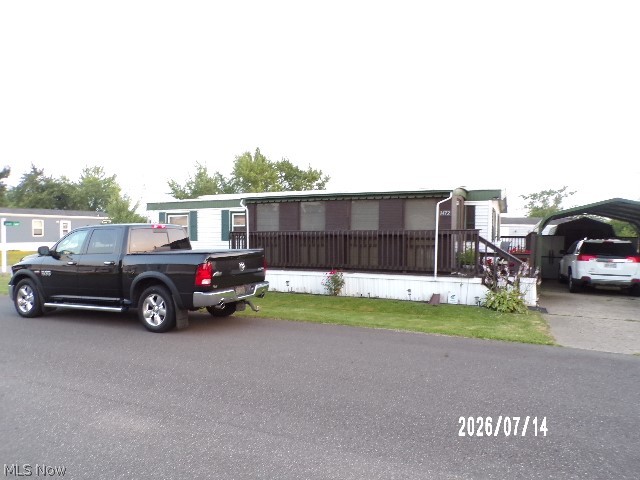 This cared for manufactured home has one large and one standard bedroom with 2 full baths and a eat in kitchen area  Theres a enclosed porch on the front with a deck on the rear. This lot offers 2 drives and one has a car port. with storage cabinets