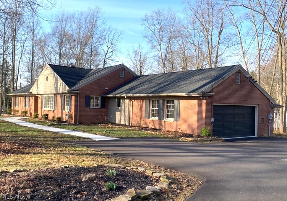 Welcome to this extensively-remodeled brick ranch home set amongst trees in Hudson's coveted Western Reserve Ranch Estates! The entry foyer leads to the great room, perfect for family and friends to enjoy its bay windows overlooking the backyard, fireplace with custom-built shelving surround and large dining area. The bright kitchen has new white cabinets and tile, granite countertops, lighting and electrical, plumbing fixtures and stainless steel double sink and appliances. Off the kitchen is a dinette and between the kitchen and garage is the new laundry room with bonus area - think crafts studio! The master bedroom ensuite has a walk-in closet and master bath with double sink vanity, quartz countertop and beautifully-tiled shower. In addition to two guest bedrooms, off the foyer is a bonus 4th bedroom/office/study. Centrally located is the guest bathroom with a soaking tub. Throughout, the home has been freshly-painted and there are new Bruce hardwood floors; the foyer and bathroom