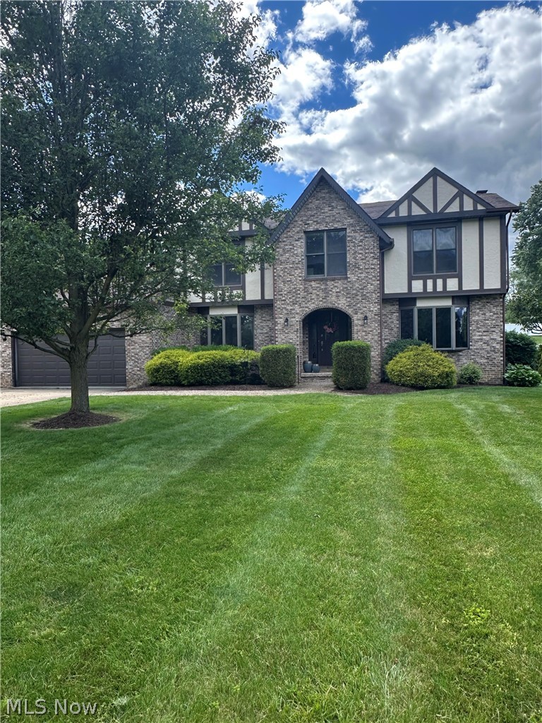 Welcome to this beautiful Tudor style home in the heart of Green! Offering plenty of space and thoughtful updates, this home features five generous sized bedrooms, including a private primary suite, three full bathrooms, a bright three season room, and above ground swimming pool and a spacious backyard with a fire pit and storage shed. Recent improvements include updated kitchen cabinets, countertops and backsplash, new luxury vinyl tile flooring throughout the first floor and a brand new furnace and central air system (2023). The partially finished basement provides the perfect space for entertaining with a recreation room and bar area, while the unfinished portion offers abundant storage and room for a workshop, home gym or hobby space. Blending timeless Tudor charm with modern updates, this move in ready homes is ready for its next owners. Scheduled your private showing today!