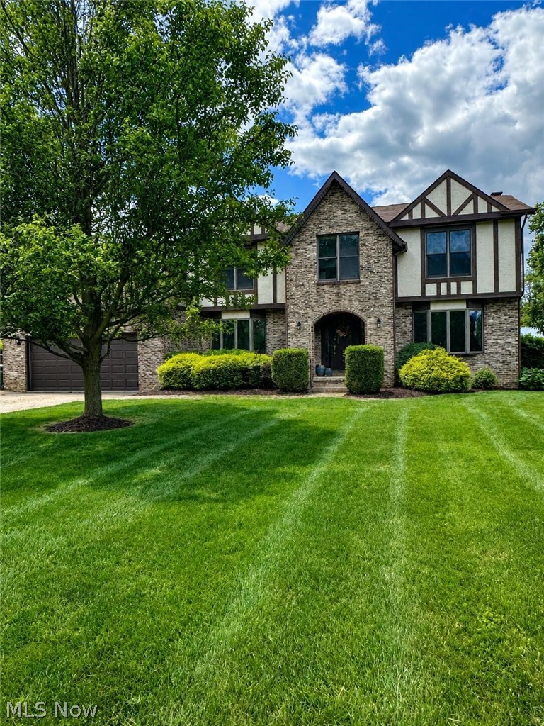 Welcome to this beautiful Tudor style home in the heart of Green! Offering plenty of space and thoughtful updates, this home features five generous sized bedrooms, including a private primary suite, three full bathrooms, a bright three season room, and above ground swimming pool and a spacious backyard with a fire pit and storage shed. Recent improvements include updated kitchen cabinets, countertops and backsplash, new luxury vinyl tile flooring throughout the first floor and a brand new furnace and central air system (2023). The partially finished basement provides the perfect space for entertaining with a recreation room and bar area, while the unfinished portion offers abundant storage and room for a workshop, home gym or hobby space. Blending timeless Tudor charm with modern updates, this move in ready homes is ready for its next owners. Scheduled your private showing today!