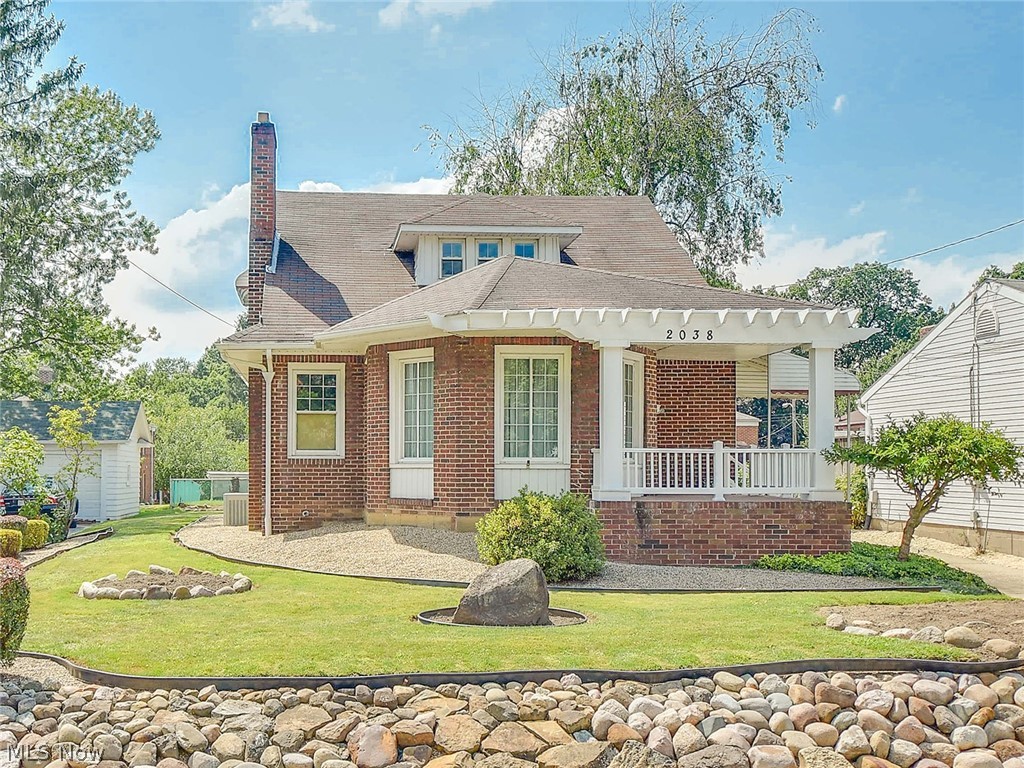Impressive Brick Cape/Colonial in desirable Falls neighborhood. Appealing curb appeal with cozy front porch,concrete driveway and attractive landscaping. The front door steps into the cozy circular sun room. This home has been maintained in excellence, extensively remodeled and kept in pristine condition. Floor plan reconfigured and well planned out to create an open concept that is light and bright with the kitchen opened to the dining room with a bay window and the formal living room with a fireplace. Custom made weathered oak kitchen cabinets built on site with corian counters,white tile back splash, huge 96"island/breakfast bar,ceramic tile floor, stainless appliances, hidden trash and recycle containers, plus a wine rack! Gorgeous hardwood floors throughout the first floor,many rooms with crown molding, newer six paneled doors and most all light fixtures replaced too. Two spacious bedrooms on the first floor with double closets plus a beautifully  remodeled bathroom with double si