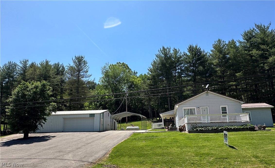 Conveniently located just minutes from Caldwell, this well-maintained home offers space, functionality, and sits on 2.1 acres. Featuring a kitchen with all included appliances and a washer dryer combo, 2 bedrooms including a primary suite with private half bath, plus an additional full bath on the main level, and a 3rd room which was used as an office. The partially finished basement adds extra living potential with a finished room complete with a shower, vanity, and tanning bed.  Enjoy multiple gathering spaces with 2 living rooms, perfect for entertaining or relaxing. Step outside to a large private deck with a propane firepit, a covered side porch, and a nice yard setting. The property includes a carport, blacktop driveway, whole-home Generac system, and an oversized detached 3-bay garage featuring full overhead loft storage along with 3 attached rear sheds offering abundant storage and workspace options.  Home is being sold in AS IS condition, and the seller is retaining all mineral rights.  Call for your private showing.