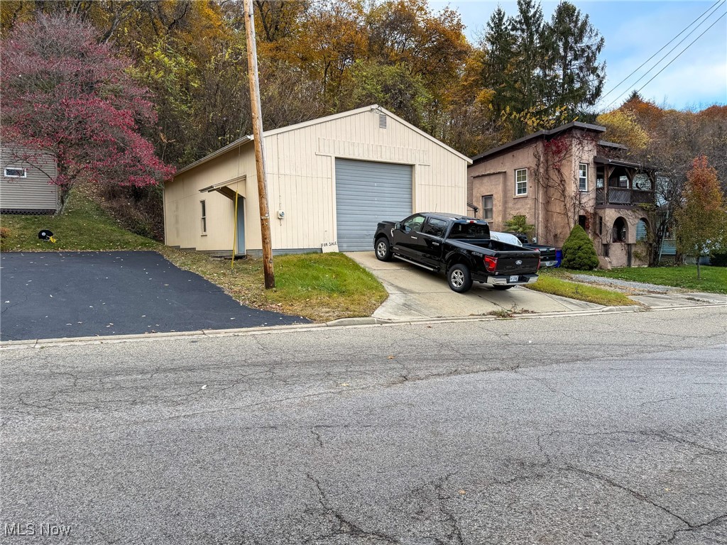 Conveniently located 30' x 40' garage with a concrete floor, electric, and a wood burner.