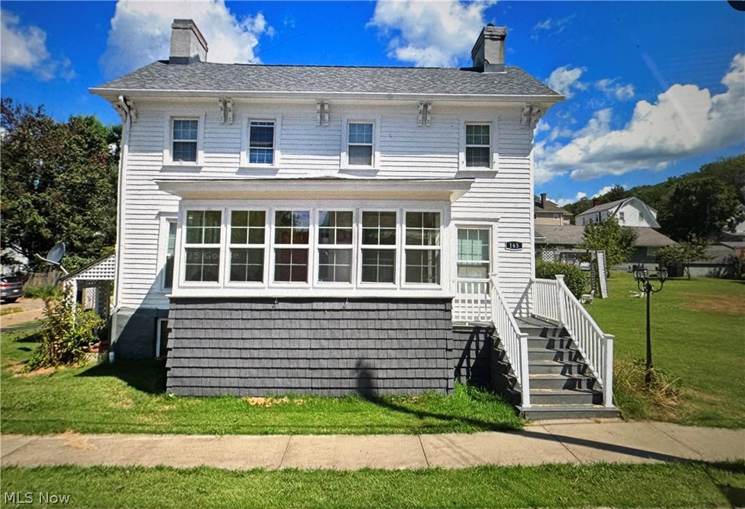 Own a piece of Wellsburg history with this well cared for colonial beauty rich in local history and thoughtfully updated for modern living. Built in 1850 and was cherished by the same family for 144 years, until its current owner’s purchase in 1994. This exceptional home underwent updates thru the years , blending historic charm with contemporary amenities. Experience the charm of original architectural details, including high ceilings, locally made stained glass in entry way (per seller), a welcoming sunporch, & classic parlor w/ WB fireplace.  An updated kitchen is a culinary dream, gorgeous countertops, stainless steel appliances,&  ample cabinetry. Enjoy a comfortable layout with a convenient first-floor laundry with additional pantry space.  Gleaming Hardwood floors adorn most of the first floor.  Retreat to the spacious 1st floor primary suite, complete with a beautifully appointed bathroom with walk in shower and large walk in closet.  Three  bedrooms on the second floor and an additional full bathroom to support family living.  Relax and unwind on the covered, back deck that features additional entertaining space with a patio and fire pit.  Easy access to the attached workshop (11x13) provides tons of space for any of your favorite hobbies.   Flat lot adjoins the home perfect for whatever your life needs-pool, garage, or fenced in yard. Accessible ramp is located on back entrance and RV electric hook up on site.   Carport with functional driveway allows a seamless flow for you and any of your guests.  20 min or less from Ohio or PA state lines…Call today to be the proud owner of this piece of history!