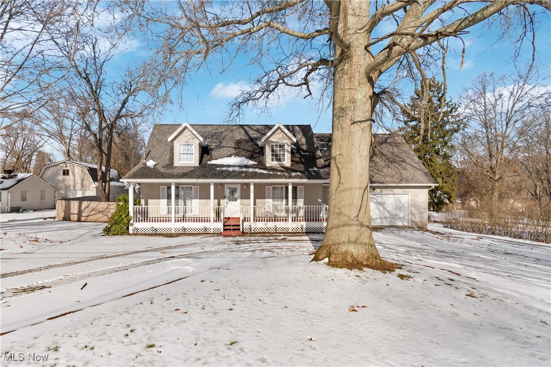 Welcome to this charming home offering a covered full length front porch to sit out and enjoy your morning coffee and a turnaround with ample parking. Bright, large living room has large windows to let the natural light shine through and is open to the dining area and kitchen that has a slider door to the large deck where you can entertain or sit around the fire pit, and swim in the pool in this huge backyard. Convenient first floor laundry room. Also on the first floor is the master bedroom that offers a bathroom with dual sinks and walk in closet. Upstairs you will find another full bathroom and two large bedrooms. There is a full basement with high efficiency furnace and sump pump, storage area. Home is very close to I-76 and Portage Lakes. On the border of Coventry and Barberton. All you have to do is move right in!