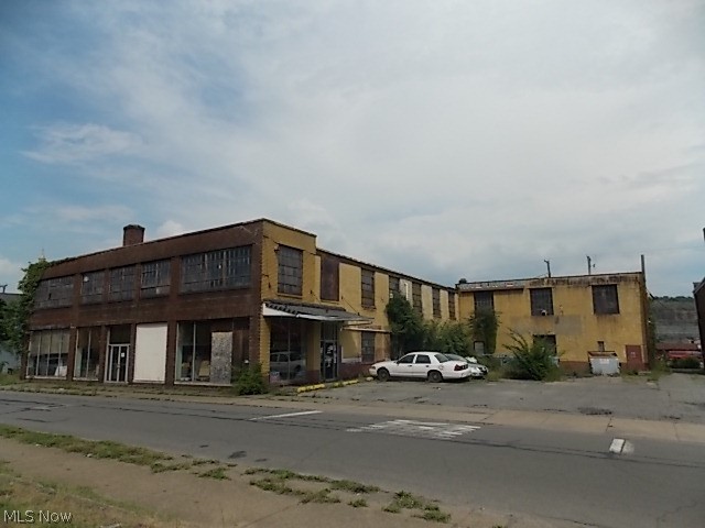2 STORY BRICK COMMERCIAL BUILDING  WITH  12,250 SQAURE  FOOT ON EACH FLOOR.MAIN FLOOR HAS WARE HOUSE WITH LOADING DOCK  DOOR.FRONT LOBBY  HAS SHOWROOM,OFFICE AND BATHROOMS.REAR ALL ACESS HAS 10 FOOOT GARAGE DOOR WITH CEMENT CAR RSMP TO 2ND FLOOR. BACK IN THE THIS WAS A PARTS STORE THE A AUTO SALES SHOP. CURRENTLY SELLERS HAVE  2 AUTO BODY TENANTS IN BUILDING .ONE RENT IS $425.00 AND THE 2ND ONE IS $400.00- BOTH ON A MONTH TO MONTH BASIS.GREAT PROPERTY FOR A A NEW START BUILDING .ALSO GREAT PARKING.PARKING LOT WITH BUILD IS ON 2 LOTS,ONE RECTANGLE LOT RUNNING THE LENGHT OF 5TH IS ACROSSED THE ALLEY AND PARKING LOT ACROSS THE STREET FROM BUILDING ARE ALL INCLUDED IN SALE.
