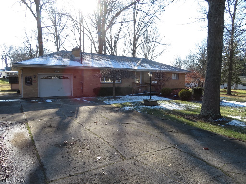 Country Living in the heart of Austintown. Minutes to shopping, entertainment, dining and freeways. This 3 bedroom, 1 bath all brick ranch home sits on a large treed lot and features a beautiful stone fireplace, newer roof, furnace and hot water tank, updated kitchen, bath and dining room, newer wood trim and 6 panel doors, and a fresh coat of paint. Hardwood floors lie beneath the carpeting in the bedrooms and hallway. The water-proofed basement features a shower, laundry, built in work bench, and large storage closet with plenty of room to create that "Man Cave". Over-sized garage, large rear porch, and outdoor storage shed round out this home. Set your appointment now and make this gem your new home before someone else does.