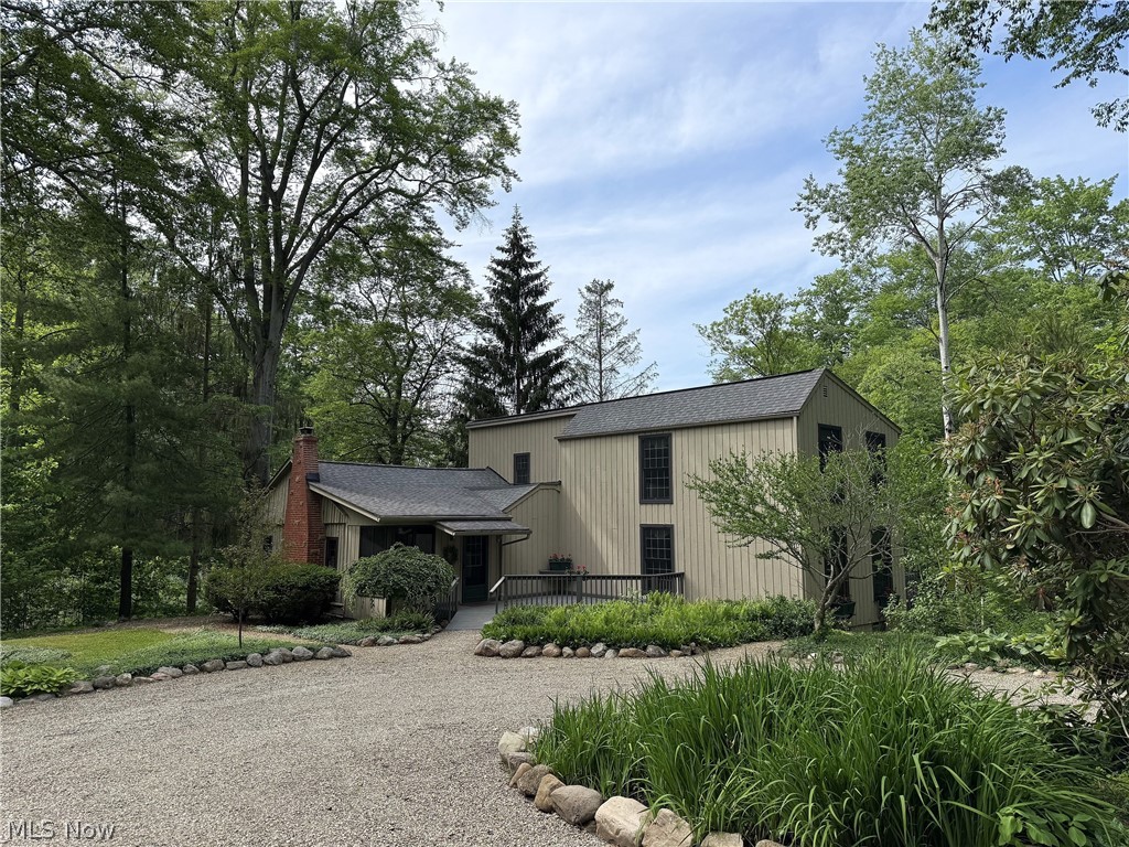 For the very first time on the market, this remarkable Colonial residence sits on a generous 2.5 acres of beautifully wooded and landscaped land, creating a serene retreat that offers both privacy and tranquility. Originally established as a cabin in the 1940s, the home has undergone significant enhancements and expansions, now featuring an expansive Great Room with a vaulted beamed ceiling, a spacious Dining area, and a Family Room adorned with a beamed ceiling and built-in elements. To maximize natural light and showcase the stunning vistas of the meticulously cared-for grounds, Pella Windows have been incorporated throughout the home, bringing in views of the two charming streams and bridges that grace the property. Large decks were added on two sides, perfect for savoring the peaceful surroundings. The upper level includes two additional bedrooms and a full bathroom, along with a Den that overlooks the Great Room. With the potential for a first-floor owner's suite, consisting of two bedrooms and a full bath, this home truly accommodates various needs. Experience the abundance of wildlife and natural beauty, complemented by the adjacent protected nature conservancy that ensures further security and privacy. What more could one desire?