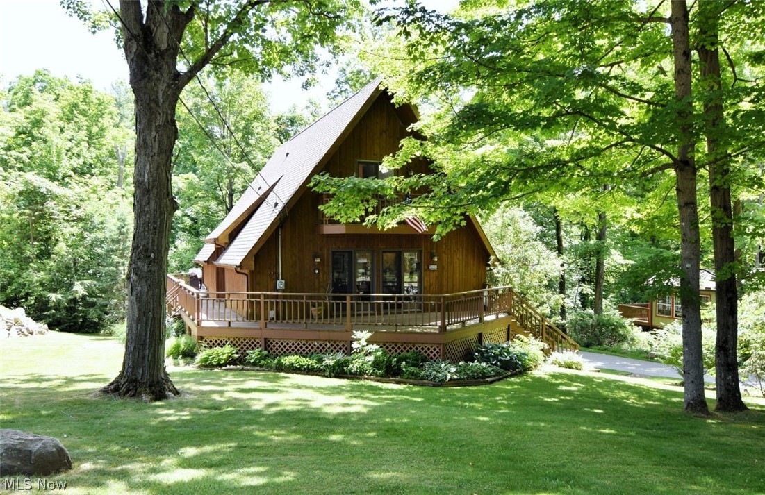 Tucked among the trees on a quiet private setting in Burton, this charming A-frame offers the perfect blend of character, comfort, and peaceful living. With 3 bedrooms, 2 full baths, and a desirable first-floor primary bedroom, the home delivers warmth and functionality wrapped in timeless architectural style.

The soaring rooflines, natural wood exterior, and inviting deck create an unmistakable retreat-like atmosphere from the moment you arrive. Inside, the home feels both cozy and open, with flexible living spaces, wooded views, and a layout that works equally well for full-time living or a weekend escape.

The finished lower-level family room adds additional space for relaxing, entertaining, hobbies, or guests, while the attached garage and storage shed provide practical convenience. Recent improvements include a brand-new roof, all new skylights, and new range.  A one year home warranty is available offering peace of mind and long-term value for the next owner.

Set on a private wooded lot with a surprisingly secluded feel, this home offers the kind of setting that encourages morning coffee on the deck, evenings under the trees, and a slower pace that is increasingly hard to find.

Conveniently located near Burton’s charming village shops, parks, dining, and Geauga County’s scenic countryside, this distinctive property is full of opportunity and personality.