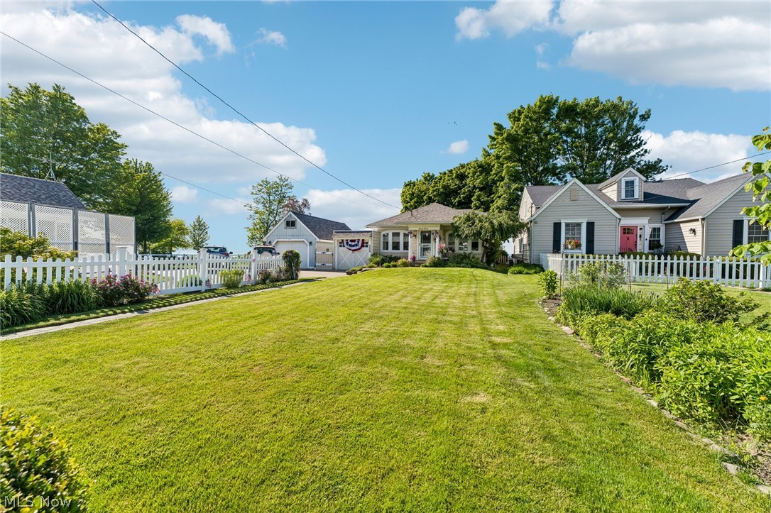 WOW! If you've been dreaming of owning a classic lakefront home with breathtaking views and timeless character, this is the one you've been waiting for!  From the moment you walk through the beveled glass French doors, you'll fall in love with the warmth and charm of this beautifully updated 2-bedroom ranch. Elegant coastal décor, rich hardwood floors, crystal doorknobs, and stunning gum-wood accents create the perfect blend of lakeside nostalgia and modern comfort. Wake up each morning to breathtaking water views right from the comfort of your bedroom. The fully renovated kitchen features quartz countertops, soft-close cabinetry, and finishes that make this home completely move-in ready. Cozy up beside the gas fireplace or retreat to the charming corner room—perfect as a home office, reading nook, or guest space—where wraparound lake views steal the show. Step outside and prepare to be amazed. The expansive two-level deck offers front-row seats to spectacular sunrises and unforgettable sunsets reflecting across the water. Whether you're entertaining friends, enjoying your morning coffee, or simply soaking in the peaceful waterfront setting, every day feels like a vacation. Additional updates include newer shaker-style vinyl siding, a brand-new roof (2026), new boiler hot steam heat (2025), two mini-split systems providing efficient heating and air conditioning, and a waterproofed basement for added peace of mind. Homes like this rarely become available. Classic lake charm, modern updates, incredible waterfront views, and memories waiting to be made—this is more than a home, it's a lifestyle. Stop scrolling and schedule a private tour​​‌​​​​‌​‌​​​‌‌​​​‌‌‌​​‌​​‌‌​​​​ today!!