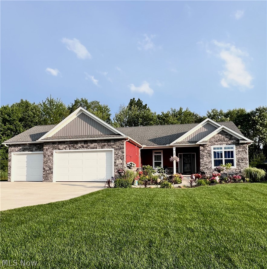 Custom-built ranch in a newer Tallmadge neighborhood features custom builder upgrades. Landscaped and ready for the coming seasons. The open floor plan begins with a welcoming foyer leading to a spacious great room with a fireplace. This floor plan offers excellent flow for everyday living and entertaining. A stunning kitchen with granite countertops and custom trayed ceiling features a large breakfast bar. The dining room has multiple windows and leads to the covered back porch, two-level patio, and gazebo. A centrally located half bath and built-in office space provide ideal convenience for remote work or a home office. The owner's suite with a full bath and walk-in closet is privately situated on the opposite side of the home from the other bedrooms and full bath. The lower level is finished with laminate flooring and painted walls and ceiling.  It features a large rec room, a luxury full bath, a multi-purpose room, and extra storage.  The impressive 3+ car garage includes a Lift master Direct drive opener for the 8ft doors. Extra workspace, hot and cold water, and a gas hookup for heat if desired.  This home has all the amenities needed for a move-in ready custom home. More photos coming soon.