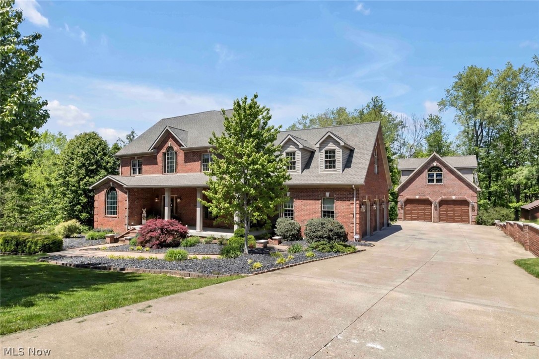 49800 Lantz Court in East Liverpool is a rare luxury retreat tucked away on a secluded, tree lined lot surrounded by wildlife, offering the perfect balance of privacy and convenience. Located just minutes from the Pennsylvania border with easy access to Beaver County and the city, this stunning 5 bedroom, 3.5 bathroom home offers over 5,000 square feet of beautifully designed living space.
From the moment you arrive, the expansive driveway, charming curb appeal, and peaceful wooded setting make a lasting impression. Inside, floor to ceiling windows flood the home with natural light, while the living room showcases one of two full brick fireplaces. The kitchen features granite countertops, abundant cabinetry, a large island with bar seating, and a casual eating nook, while the formal dining room provides an elegant space for entertaining. Sliding glass doors off the kitchen lead to an elevated patio and balcony overlooking the private wooded setting.
The primary suite serves as a private retreat with a soaking tub and separate standup shower. Additional bedrooms are spacious and cozy with convenient bathroom accommodations nearby, plus a second floor laundry room for added convenience.
The finished walk out basement is built for entertaining with the second full brick fireplace, wet bar, expansive recreation space, and direct access to the lower patio and outdoor grill area. Outside, you’ll find multiple entertaining spaces, a hot tub patio, charming playground, and peaceful wooded surroundings creating a true outdoor escape.
Car enthusiasts and hobbyists will appreciate the climate controlled attached 3 car garage, additional heated and cooled 4 car garage with potential living quarters above, two storage sheds, and new roof in 2023. A one of a kind property offering luxury, privacy, and endless possibilities.