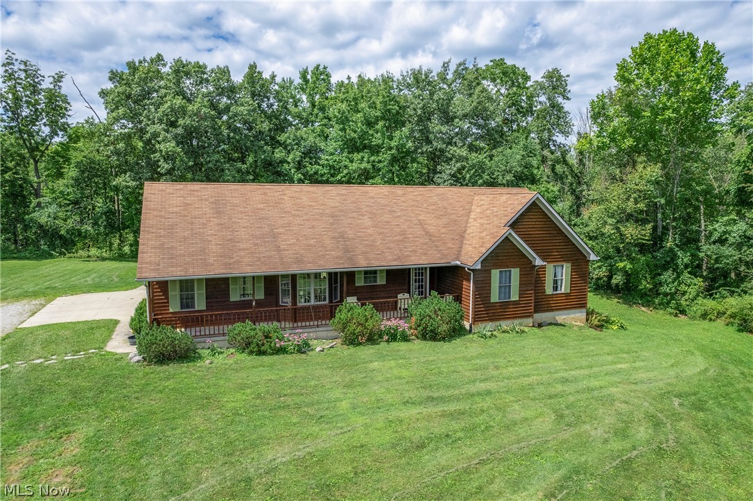 Ranch built in 2003 on a beautiful 8.372-acre lot. Wellington schools. Outbuilding 30’ X 40’, metal building with cement floor, 100 amp electric.  House has an attached 3-car garage, the outbuilding easily holds 4 cars without a lift, outbuilding ceiling is high enough for a lift.  Master bedroom with walk-in closet and en-suite bathroom.  Large kitchen, all kitchen appliances stay.  Kitchen, dining room, laundry room, foyer & great room updated LVT flooring. Great room French door walks out to a deck. Yard also has a pergola area with natural landscaping stone area, a great area for relaxing & grilling. Basement is a walk-out with French doors, poured cement walls with tall ceilings equal to a 13-course cinder block height – ready to be finished if you need the extra space. Water currently holding tank, Rural water is available at the street. In the woods behind the house is a small pond & a creek. Yard is graded away from the house. Septic & leach field all gravity feed, lift station