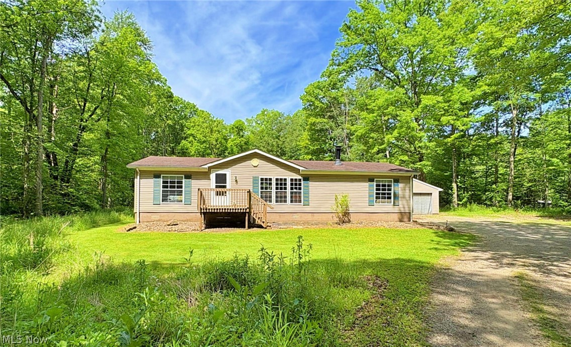 Enjoy peaceful country living in this 3-bedroom, 2-bath ranch situated on a private, wooded 5-acre lot just minutes from the local lakes. The property features a pond at the rear, beautiful landscaping, and a garden area that creates a serene outdoor setting. A detached garage offers space for two vehicles plus a workshop, providing plenty of room for hobbies, storage, or projects. Whether you're enjoying the privacy of your acreage or spending time on the nearby lakes, this property offers the perfect blend of comfort, nature, and tranquility.  Hurry and schedule your showing today!