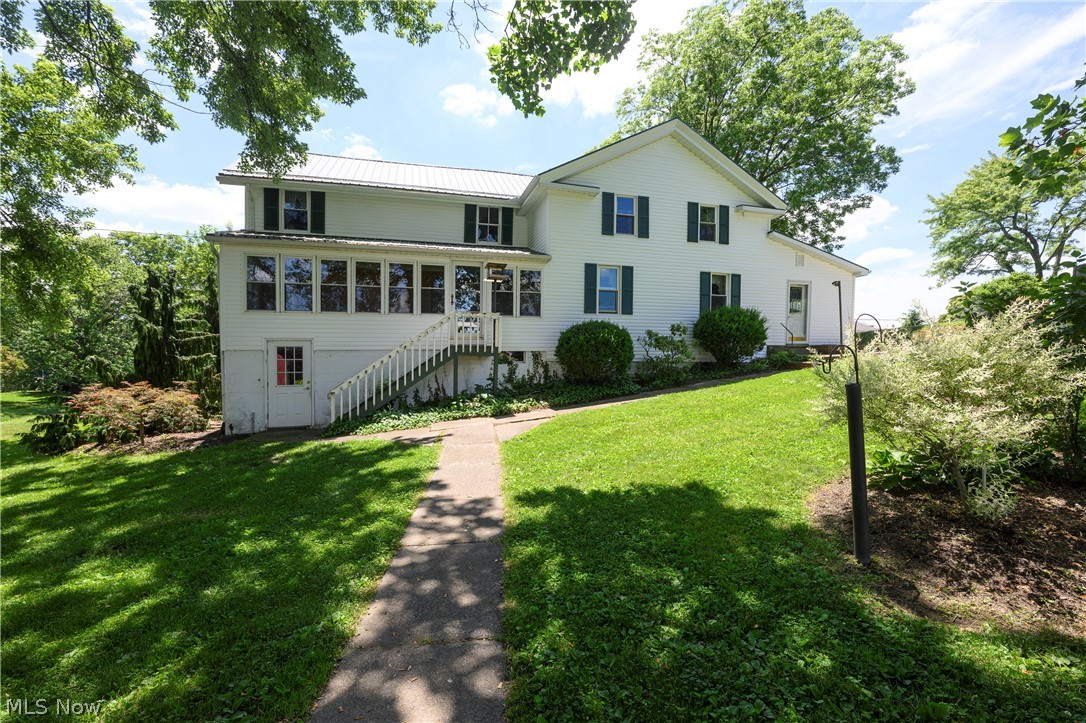 Welcome all to this amazing home and piece of history, located at 12201 King Church Ave NW, in lovely Uniontown! Nestled on nearly 3 acres and just steps away from Lake High School, this charmer offers 5 beds, 2 full baths, nearly 2500sqft of cozy living space, AND over 8,000sqft of barn space for all those hobbyists out there! What started off as a humble log cabin built in 1850; this home was lovingly transformed into the full-size-farm-style home you see today! The first floor offers a massive walk-in pantry just off of the spacious kitchen, a tranquil 4-season room overlooking the property and barns, a wonderful family room/living area offering extreme peace and tranquility, the first guest bedroom which is currently used as an office space, as well as the first floor master just steps away from the first of two full bathrooms! Upstairs offers an extremely unique layout with a couple flex spaces in between the two primary bedrooms and second full bath! Sellers have added newer metal roofs to both larger barns as well as the main dwelling. The windows, septic system, furnace, and AC are also newer for added peace of mind! Heading outside, you will be greeted by an absolutely stunning lot complete with fruit trees, grape vines, berry bushes, and a massive garden area; talk about homestead ready! Also on the property you will find a massive 2 tiered barn, an additional barn, block workshop with full carpentry setup inside, and a beautiful creek that runs through the center of the property!  This home comes with compliant well and septic POS, and will also come with a home warranty for new owners!  Call ME or your other favorite agent for any and all questions or your private showing to this truly and remarkably unique home!