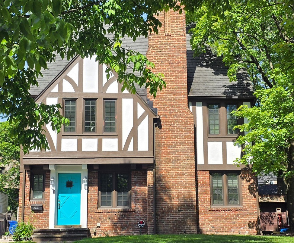 Charming Brick Tudor with distinctive upgraded Turquoise exterior doors is move-in ready! Gleaming hardwood floors, crown molding and coved arches greet you in the spacious Living and Dining Rooms arranged in classic “L” shape for great entertaining flow! Door in Living Room leads to covered porch, perfect for enjoying summer breezes! Updated Kitchen with granite counters, ceramic tile floors, and newer Stainless Steel appliances including new (2025) dishwasher. Also convenient Coffee/Breakfast Bar and ample Maple cabinetry! Pantry and extra storage space off Kitchen. Rear door leads to private back yard with play area and brick paver patio! Three sizable bedrooms on second floor share an updated full bath. Third floor guest or teen suite includes bedroom and full bath plus attic space for tons of storage! Lower level with laundry and mechanicals. Cedar Wood Shingle siding on sides and back of the house painted two years ago. Two car plus garage replaced 2008. Furnace 1 year old, newer AC! Updated Electrical. Many newer windows throughout! HSA Home Warranty! Will be Shaker Heights Point of Sale compliant. Must See!!!
