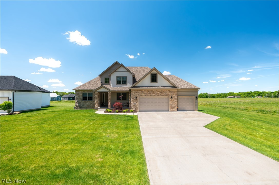 Why build when this beautifully designed 2022 build already offers the upgrades, space, and thoughtful details you want all while being on the cusp of Millennial Moments & situated in Canfield School District. Beautifully finished, thoughtfully designed,& move-in ready, this exceptional home offers comfort, style, flexibility, & room to grow. Step inside to soaring ceilings, 80-inch doors, abundant natural light, and an inviting layout ideal for everyday living and entertaining. Luxury vinyl plank flooring and soft carpeting create the perfect blend of style and comfort. The welcoming foyer borders the formal dining room and opens to the stunning great room, warm and inviting with a beautiful gas fireplace. The formal dining room provides the perfect setting for holidays or gatherings.  The heart of the home is the gorgeous kitchen, featuring quartz countertops, ceiling-height cabinetry with glass accents, a stylish backsplash, stainless steel appliances, a spacious island, pantry, and generous prep space. The adjoining dinette offers glass sliders leading to the backyard for easy indoor-outdoor entertaining.The sought-after first-floor owner’s suite offers a comfortable oasis with hardwood floors, oversized walk-in closet & spa-like en-suite bath, marble tile finishes and a large walk-in shower. The first-floor laundry room and half bath add convenience for easy one-floor living. Upstairs includes a spacious landing leading to three generously sized bedrooms and full bath. The 12x22 unfinished bonus room offers endless possibilities for a game room, media room, office, or fitness. Expansive unfinished basement, impressive ceiling height and endless potential for future living space, recreation, or storage.Outside, enjoy a backyard built for fun, with a concrete patio, Oasis heated semi- inground pool, play yard to stay and all enclosed with vinyl fencing. Attached three plus car garage offers plenty of space for your vehicles, outdoor equipment and lawn care needs.