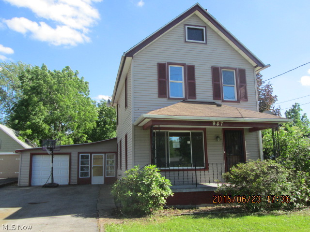 Charming vinyl sided 2 story with tandem 3 car garage.