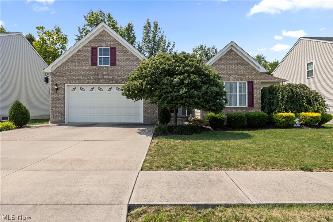 Beautifully upgraded and meticulously maintained, this exceptional ranch offers over 1,950 square feet of thoughtfully designed living space. Built with numerous upgrades beyond the builder's standard finishes, this home combines quality craftsmanship with comfort and style. Step inside to find 9 foot ceilings throughout, beautiful engineered hardwood flooring and a cozy gas fireplace that creates a warm and inviting living space. The kitchen features upgraded granite counter tops, tile flooring, a large island with seating, and opens seamlessly to the dining area and living room. A conveniently located main level laundry room adds everyday convenience. The spacious primary suite offers a private retreat with a large walk in closet and en suite bath featuring a double vanity and walk in shower. The expansive 9 foot poured basement provides exceptional storage and future finishing potential. The outdoor living space is equally impressive, featuring an expansive paver patio with a built in fire pit, decorative seating wall, and covered rear porch with a natural gas grill hookup. Curb appeal is enhanced by the beautiful brick front exterior, decorative garage window, California roof with 30 year shingles, and leaf filter gutter protection. To top it all off, this home offers the added benefit of a tax abatement, helping reduce property taxes and savings for the next owner. Don't miss your opportunity to own this exceptional home. Schedule your showing today!