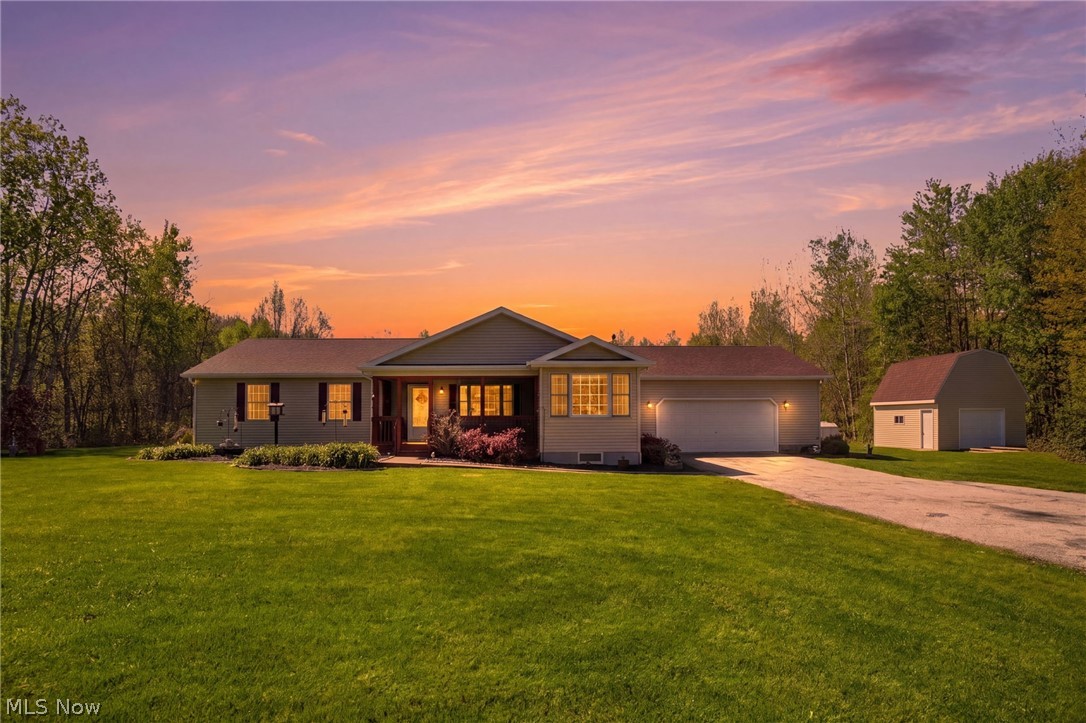 Offered for the first time, this exceptionally rare, one-owner Ranch presents a compelling blend of functional design, and lifestyle-driven amenities-all set on 2.39 acres w/the added advantage of city water, a true rarity in a country setting. The main level features an open-concept layout that seamlessly connects the principal living spaces. A beautifully proportioned living room anchors the home, highlighted by a striking fireplace that serves as both a visual focal point and a warm gathering space. The adjacent eat-in kitchen is complemented by a flexible secondary dining area, equally suited for formal dining or a multi-purpose lifestyle space. Three generously scaled bedrooms and 2 full baths provide comfortable, single-level living, enhanced by fresh interior paint and brand-new carpeting. Recent improvements-including a newer roof (approximately two years old) and updated glass in most windows and the patio door-offer added value. The fully finished lower level expands the home's livability and entertainment capacity, featuring a custom bar crafted from the former wine press establishment in Painesville, an authentic conversation piece with rich character and history. Outdoor living is equally impressive. A tiered deck provides multiple levels for relaxation and entertaining, enhanced by a pergola-covered section for shaded comfort. The in-ground pool, complete with a newer liner (2025) offers seasonal enjoyment. A screened front porch adds yet another dimension of usable space, allowing for quiet mornings or evening relaxation. Additional features include an oversized 2-car attached garage and a versatile barn offering valuable storage. The property is accented by beautiful landscaping, including an apple tree and a sour cherry tree. This property represents a rare combination of tranquil, rural atmosphere while remaining conveniently close to local amenities, Lake Erie, wineries, and GOTL.
