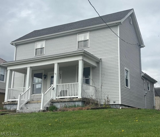This attractive two story home offers small town charm with modern updates with a spacious updated kitchen w/range & refrigerator, a beautifully updated bath, a large living room with wood floors, 3 bedrooms, a first floor laundry w/a half bath vinyl siding, updated furnace w/central air, a large font porch, a brick patio in back along with a paved parking pad & storage building, and a great location convenient to local parks and shopping.