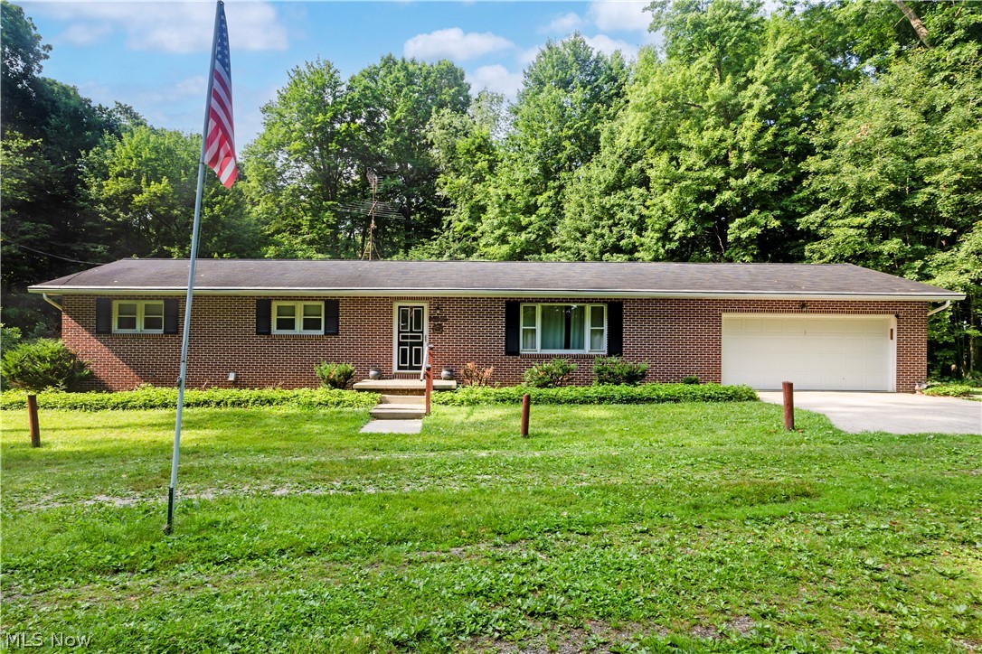 If you've been looking for a little more space and privacy, this brick ranch on over 4 wooded acres is worth a look! Tucked away in a peaceful setting, this home offers multiple living areas, giving everyone room to spread out and enjoy. The partially finished basement provides additional space for a family room, rec area, or home office. Outside, you'll find a spacious deck to relax and take in the wooded views, a two-car attached garage, and a 40' x 28' outbuilding that's perfect for storage, a workshop, or all your outdoor toys. With a private setting and plenty of room both inside and out, this property offers a lot of potential and the best of country living.