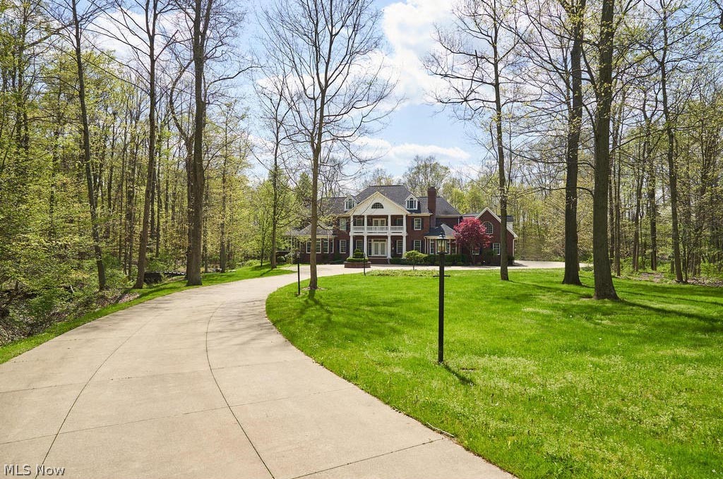 Absolutely gorgeous, cul-de-sac secluded setting in idyllic North Bath Estates. Private gated entrance winds through tree-lined drive to 4+ acre estate. Brick Georgian Colonial with nearly 8,000 finished square feet, PLUS finished lower level provide space for relaxation and entertaining alike (total over 10,000 square feet). Incredible light and views. Great Room with 20' ceilings, Music Room, Paneled Library, Parlor, Formal Dining Room and first floor bedroom suite radiate out from Foyer and center Kitchen/Office hub. Fabulous screened porch with new stamped-concrete floor. Gourmet Kitchen with cherry cabinetry, granite and Viking Range. Mudroom with cubbies and Laundry. Second floor includes Master Suite with spacious closet and Laundry, two additional bedrooms with Jack and Jill Bath, and Bedroom/Office/Bonus Room with separate entrance! Third floor bedroom or Lounge. Extensively finished lower level with workout room, playroom, media room, billiard room, wet bar and plenty of storage. 6-car garage! Outside enjoy your in-ground pool, terrace, green space and woods with creek (golf cart path winds through the woods). A wonderful neighborhood just minutes from shopping, dining and highways. Call today for your private showing.