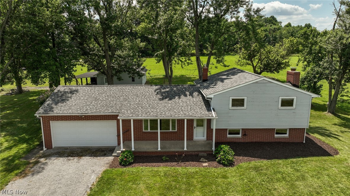Have you been dying to find a place on a little land, with a solid house & an incredible outbuilding??  It's your luck day!  Located in the North Industry/Canton South area, just a few minutes to groceries, coffee & restaurants, while still feeling like you are in the country.  This 1.26 acres is boarded only by 1 neighbor, then surrounded by undeveloped fields & woods!  The old horse barn was completely remodeled & converted into an incredible garage, work shop, man cave or use as an actual barn!  New roof & gutters 2021, fully insulated, electric (separate panel box & lots of outlets) gas heater, cement floor, a garage door, 2 man doors & a huge loft/storage area!  Oh & a carport/lean to as well!  The secondary driveway to the building has become grass, but could be put right back in place.  Back to the house, there is a wonderful paver patio that will take you into the main level.  Open concept at it's best!  So full of natural light, the big living room opens right to the fantastic kitchen.  The custom made center island is a show piece for sure!  Expansive granite top, covering tons of well thought out storage that you will love!  Additionally, room for seating around the island, great counter space & all appliances included.  The ultra durable grouted vinyl floor covers the kitchen & dining area!  Up a short flight, you will find 3 comfortable bedrooms, all carpeted & with updated lighting.  A hallway closet & semi-updated full bath completes this level.  Down to the lower is the second full bathroom, a wonderful laundry room with walk-out to the back, then large family room with wood burning fireplace!  Next, the unfinished basement level eliminates all your "split level storage worries", with tons of open space!  Now for the updates- brand new well pump 2026, roof & gutters (with covers) 2021, all windows (with the exception of 3) replaced, new lighting throughout, newer living room carpet, washer 2025, furnace & A/C 2015 & chimney tuck pointed!  MUST SEE!