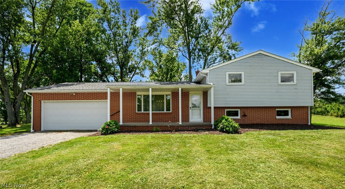 Have you been dying to find a place on a little land, with a solid house & an incredible outbuilding??  It's your luck day!  Located in the North Industry/Canton South area, just a few minutes to groceries, coffee & restaurants, while still feeling like you are in the country.  This 1.26 acres is boarded only by 1 neighbor, then surrounded by undeveloped fields & woods!  The old horse barn was completely remodeled & converted into an incredible garage, work shop, man cave or use as an actual barn!  New roof & gutters 2021, fully insulated, electric (separate panel box & lots of outlets) gas heater, cement floor, a garage door, 2 man doors & a huge loft/storage area!  Oh & a carport/lean to as well!  The secondary driveway to the building has become grass, but could be put right back in place.  Back to the house, there is a wonderful paver patio that will take you into the main level.  Open concept at it's best!  So full of natural light, the big living room opens right to the fantastic kitchen.  The custom made center island is a show piece for sure!  Expansive granite top, covering tons of well thought out storage that you will love!  Additionally, room for seating around the island, great counter space & all appliances included.  The ultra durable grouted vinyl floor covers the kitchen & dining area!  Up a short flight, you will find 3 comfortable bedrooms, all carpeted & with updated lighting.  A hallway closet & semi-updated full bath completes this level.  Down to the lower is the second full bathroom, a wonderful laundry room with walk-out to the back, then large family room with wood burning fireplace!  Next, the unfinished basement level eliminates all your "split level storage worries", with tons of open space!  Now for the updates- brand new well pump 2026, roof & gutters (with covers) 2021, all windows (with the exception of 2) replaced, new lighting throughout, newer living room carpet, washer 2025, furnace & A/C 2015 & chimney tuck pointed!  MUST SEE!