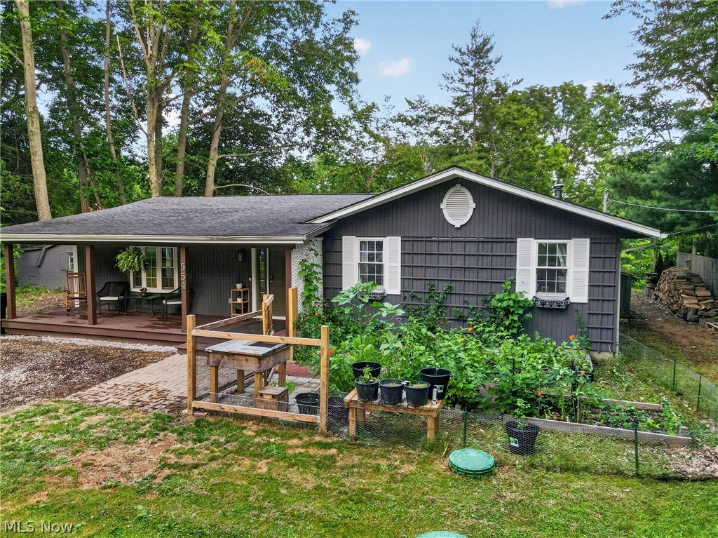 Tucked along a wooded bend of the Grand River, this charming ranch is the kind of home you dream about,  where every window frames the trees, the deck overlooks the water, and there's a story in every corner. Inside, an open-concept living area is anchored by a wood-burning stove with a stone hearth, the perfect spot to gather on cool Ohio evenings. The kitchen offers plenty of cabinetry, a window over the sink looking out to green treetops, and an adjoining full bathroom with laundry for everyday convenience. Whether you're looking for a peaceful full-time residence or a weekend escape, 554 East River View Drive offers privacy, character, and true Grand River frontage that's hard to find. Come see it for yourself!