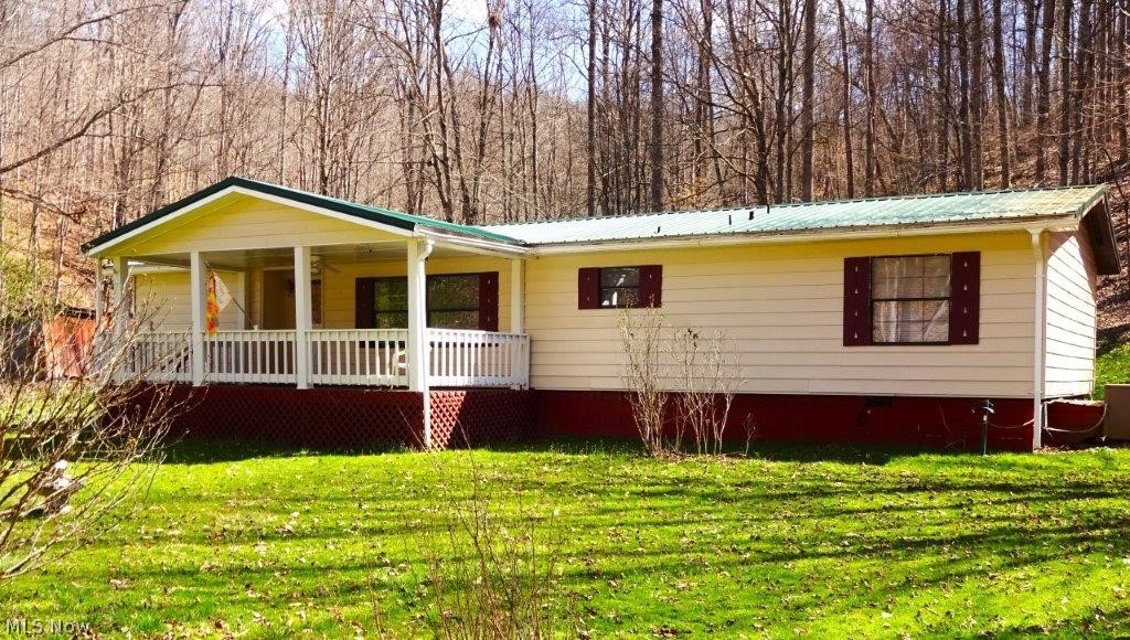 Beautiful private country location. Mostly level 1.8 acres features manufactured home, 3 bedrooms, 2 full baths, welcoming foyer, master bedroom, walk-in closet. Spacious living room, kitchen with open bar area to dining room with fireplace (wood stove), utility room. Baseboard heat plus central heat/air. Well water ( good water per owner), septic. 10yr old roof. 10x16 storage building. 10x24 front porch, nice back porch 13x52, large fenced garden area. Small stream boarders property. No zoning and no restrictions. Storage shed. Nicely landscaped. Lemon tree. 1/2 mineral rights. Home does need some TLC. Located between Spencer and Ripley off Rt 33. Quiet location, property is located on a dead end road. Short drive to "Public Wildlife Hunting Area" and also Elk Fork Lake for fishing. Lots of wildlife. Easy level access.