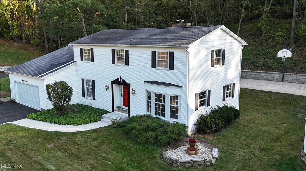 This charming two-story house, built in 1972, boasts a wealth of updates while retaining its classic appeal. The seller has recently enhanced the home with new flooring throughout, a complete renovation of all the bathrooms, and a brand-new refrigerator, making it both stylish and functional. 

Situated on two parcels, the property features a welcoming new sidewalk leading up to a cozy front door, and from this vantage point, you can turn around and take in a breathtaking view of the neighborhood.  The enclosed back porch, fitted with new windows, offers additional living space that's perfect for relaxation. 

Inside, you'll find a warm and inviting atmosphere, highlighted by a wood-burning fireplace, which is ideal for cozy gatherings in the colder months. For those who love outdoor activities, the spacious backyard includes a family-sized basketball court, perfect for play and entertaining.

Practical features of the home include an outside electrical box with a meter disconnect and ample storage space throughout the property. With four bedrooms, two full baths, and two half baths, this home is designed for comfort and convenience. It holds a treasure trove of memories and has plenty of room to create even more.